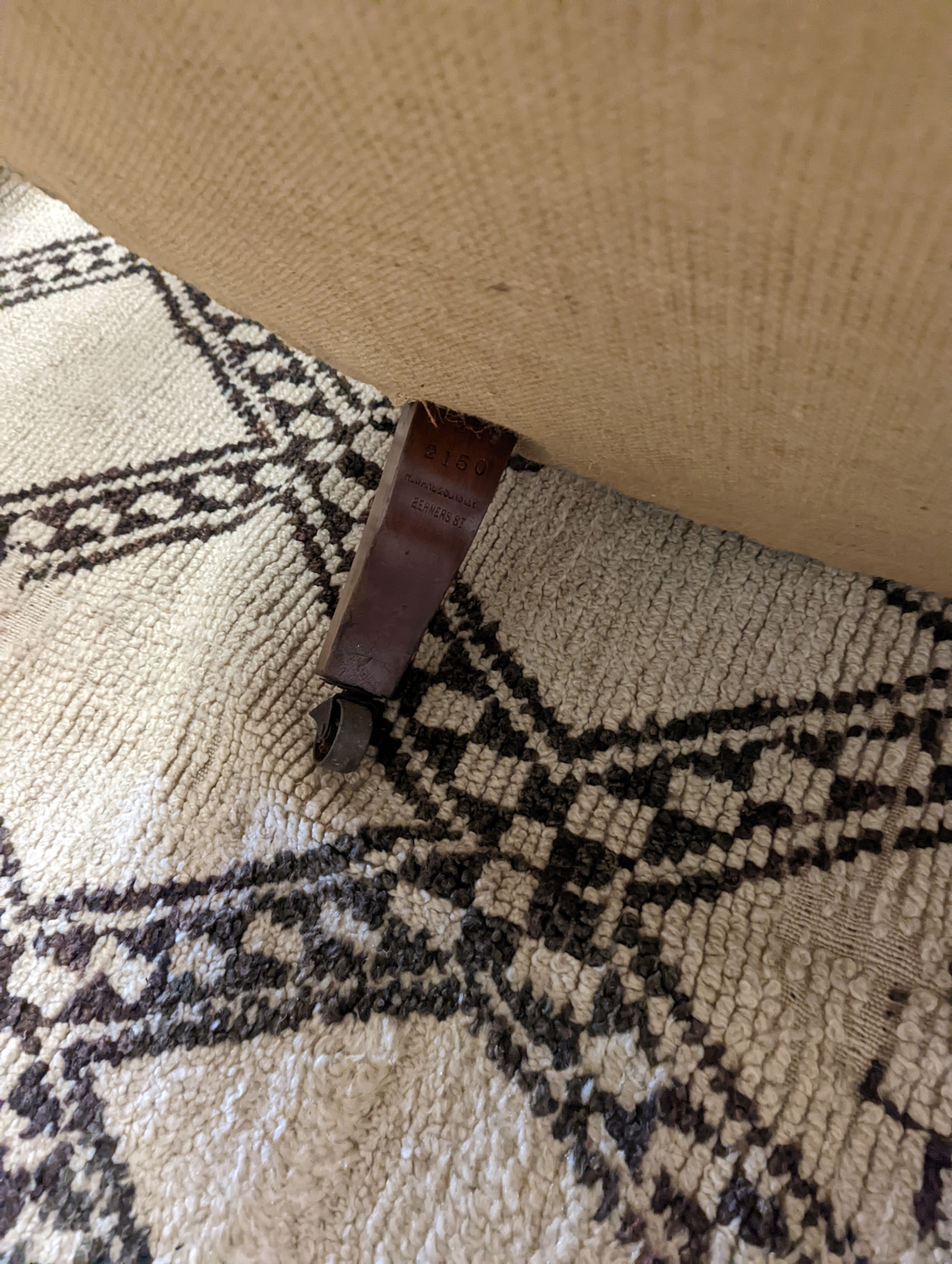 A Victorian upholstered settee with turned walnut legs, fitted brass castors, length 188cm